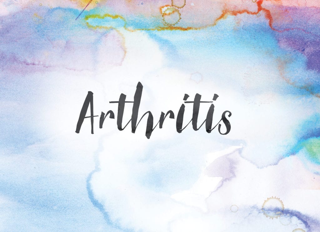 The word Arthritis concept and theme written in black ink on a colorful painted watercolour background.