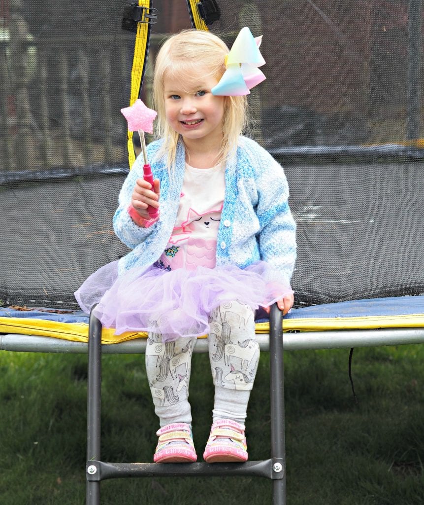 Lelli Kelly Hearts Velcro Shoes from Jakes Shoes - Aria sitting on the trampoline