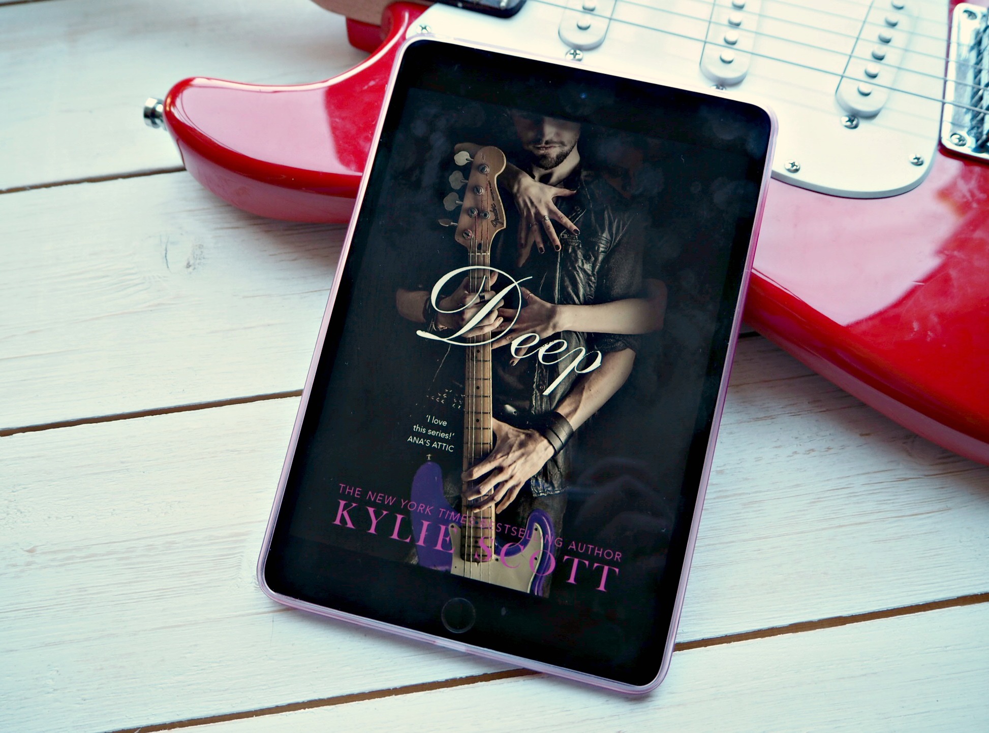 Image of Kindle on a guitar with the cover of Deep by Kylie Scott on the kindle