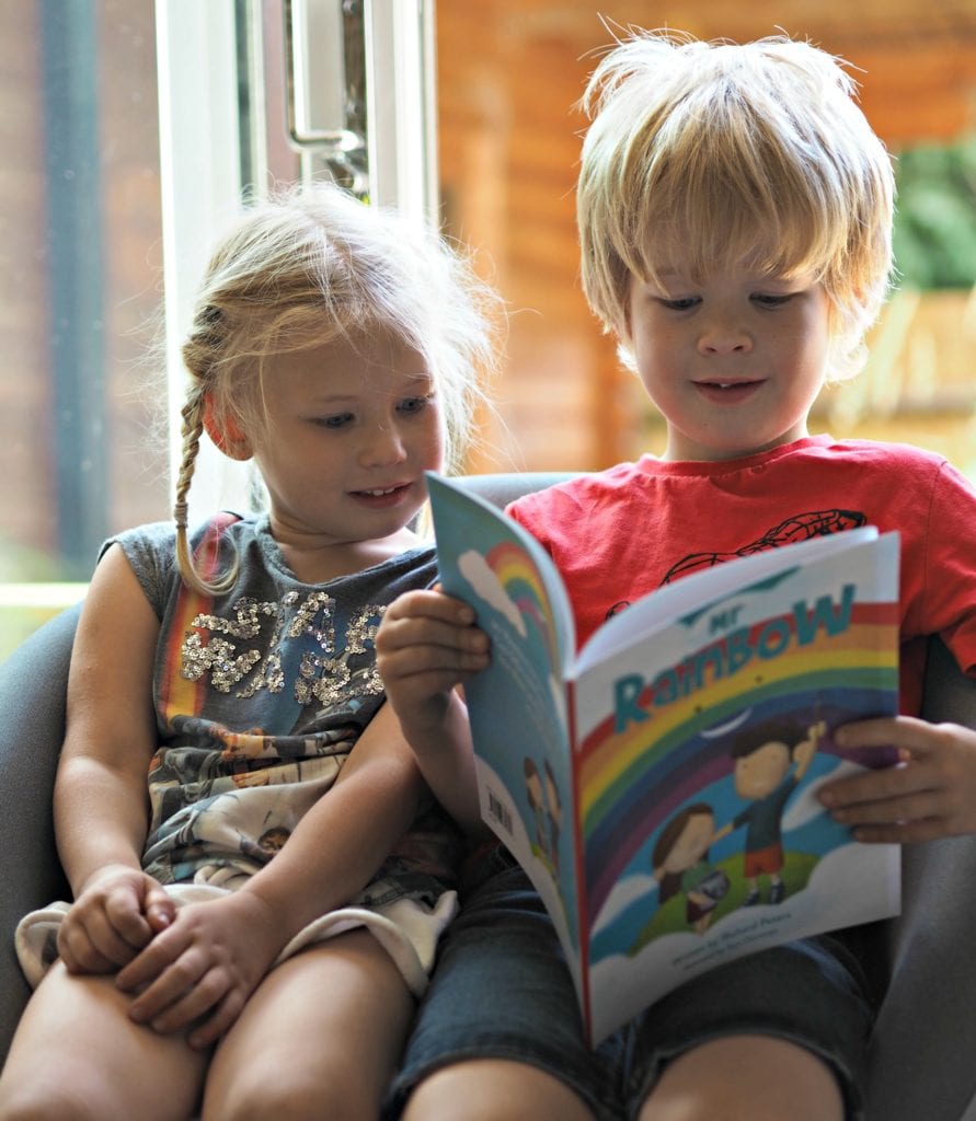 Logan and Aria reading Mr. Rainbow