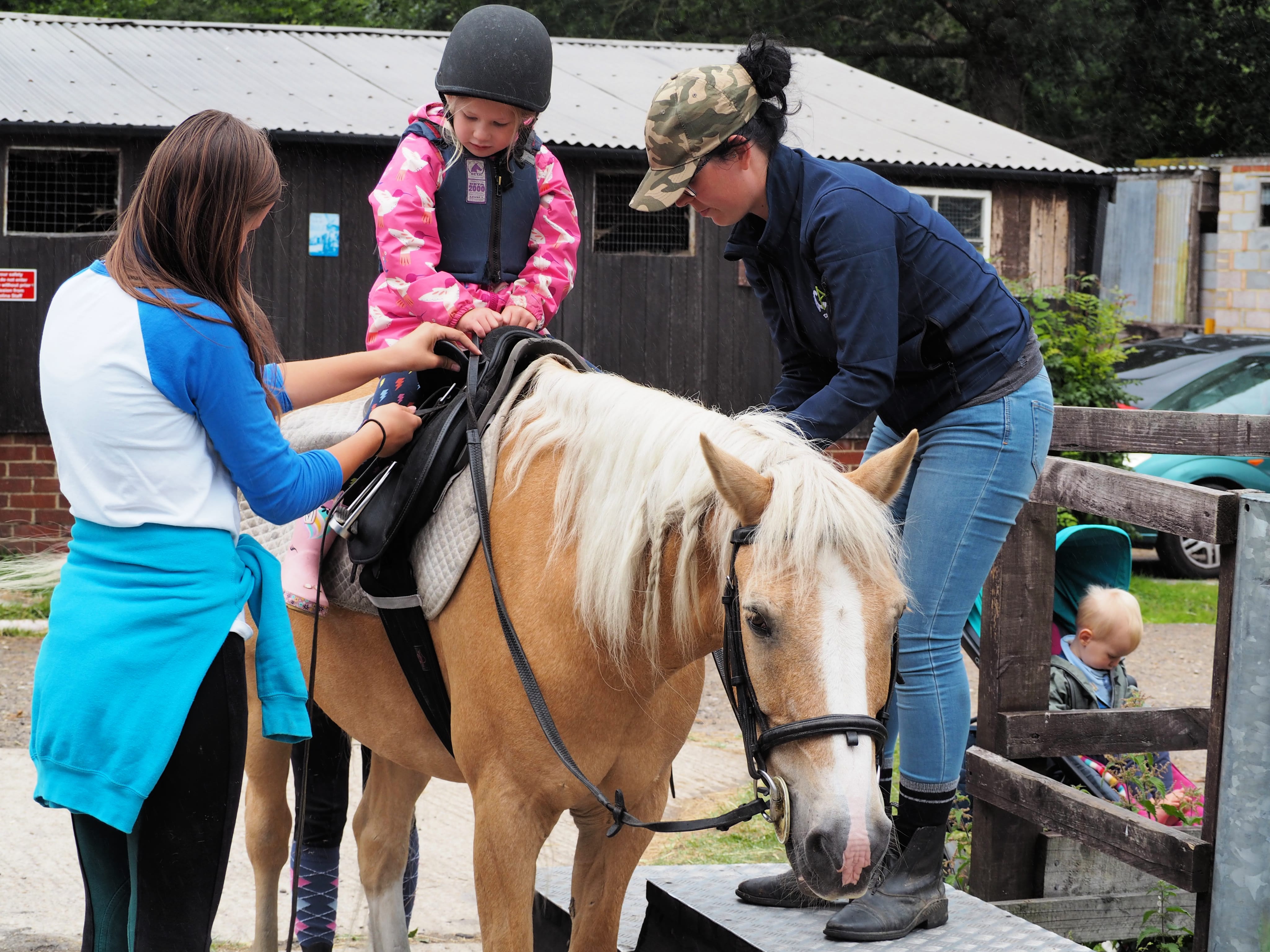 Aria getting on the horse