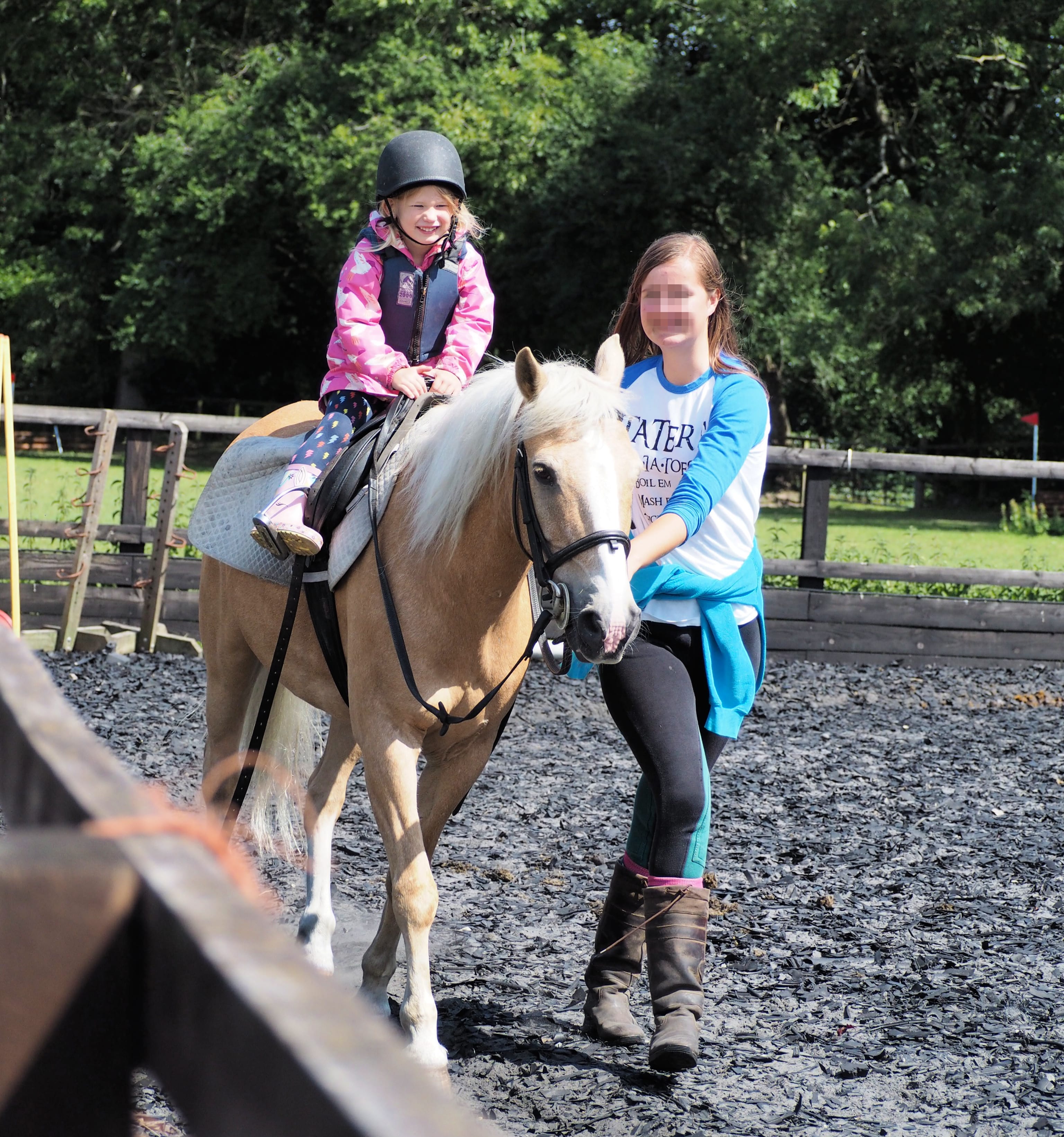 Aria grinning in her riding lesson