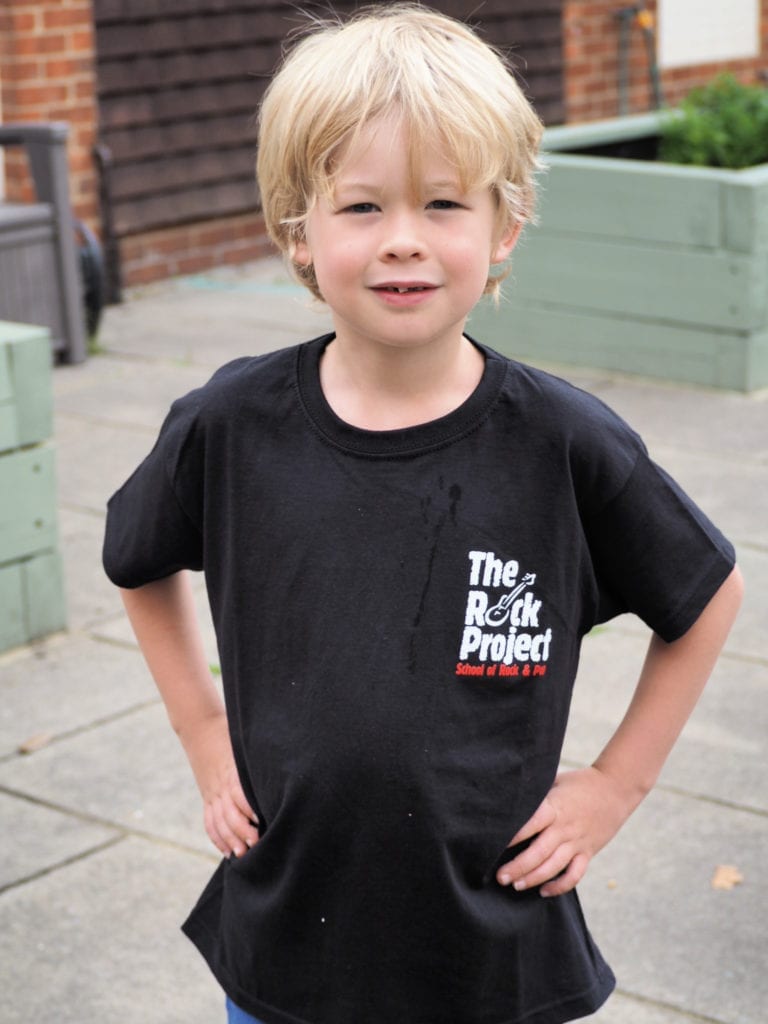 Logan in his rock project t-shirt