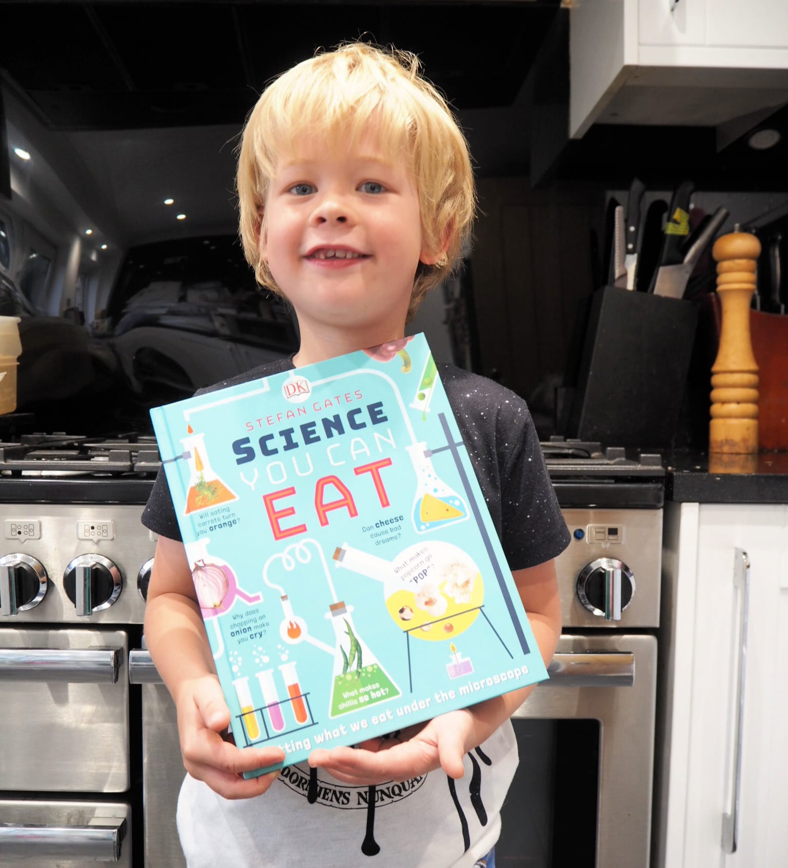 CHILDREN'S BOOK REVIEW: Science You Can Eat - Logan holding the book