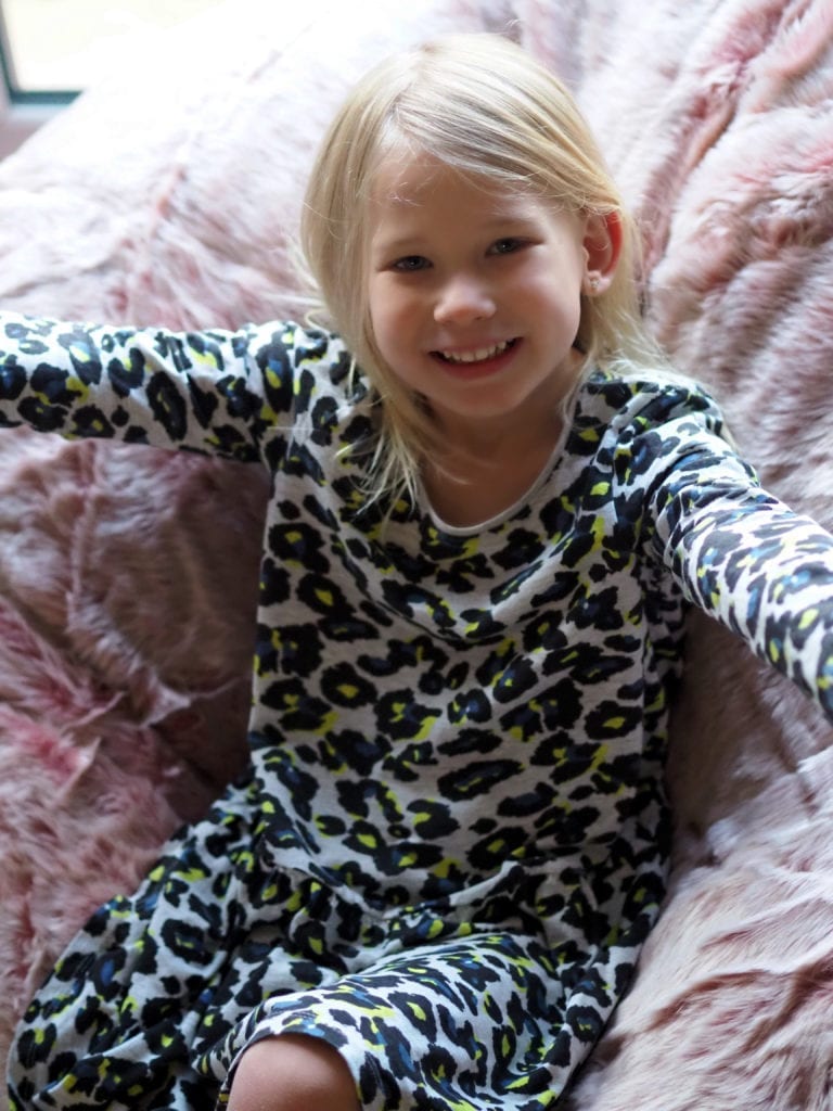 Aria sitting and smiling on the beanbag