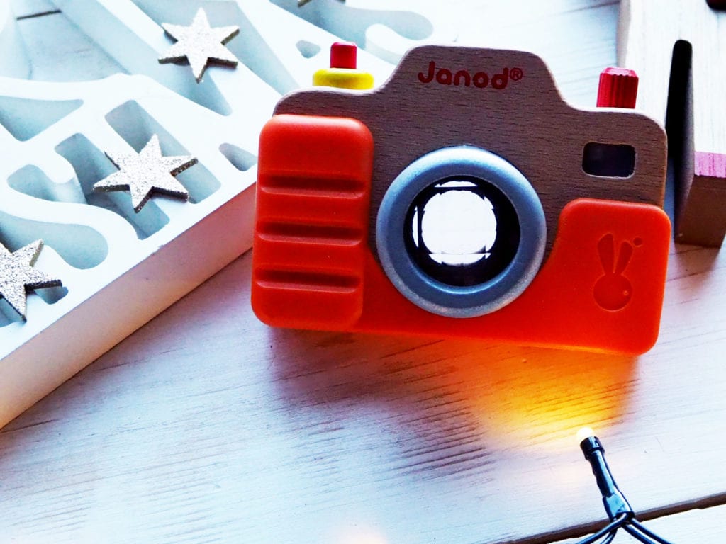 Picture of wooden toy camera with Christmas sign and lights