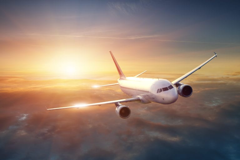 My Tips for When your Partner Travels with Work - Airplane in the sky at sunset