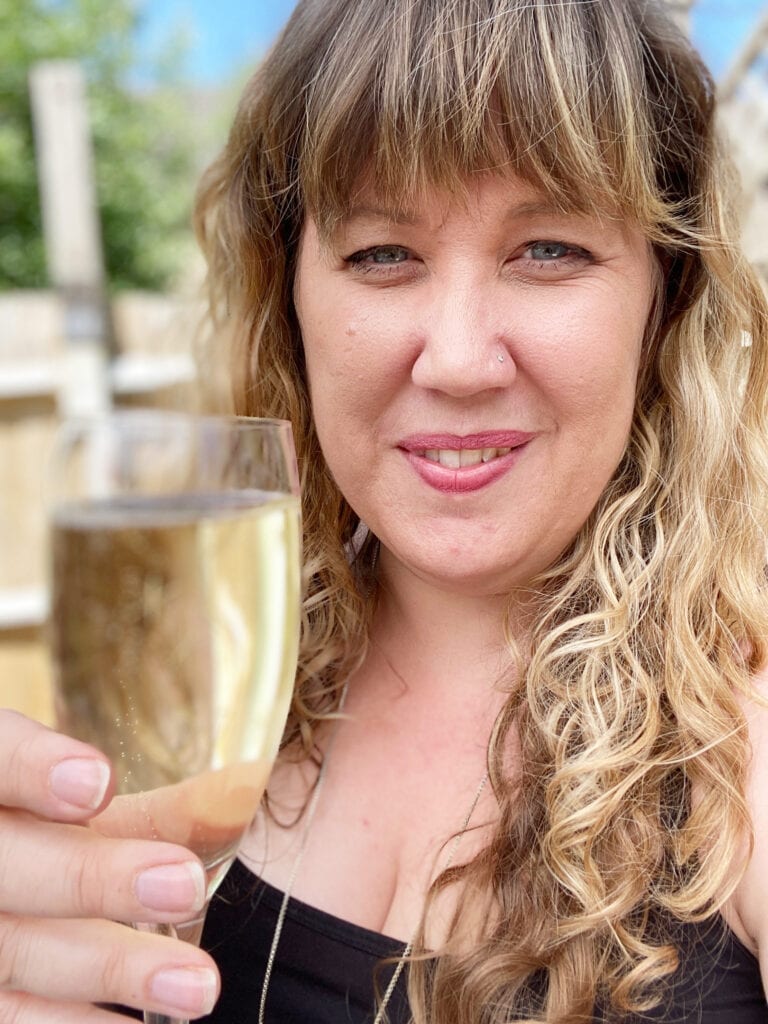 A picture of me holding a glass of prosecco