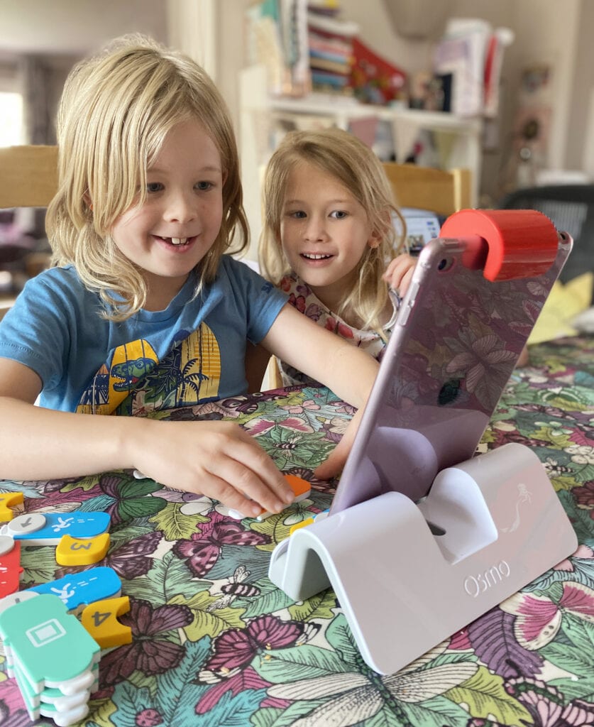 Picture of two children smiling and playing the Osmo on an iPad