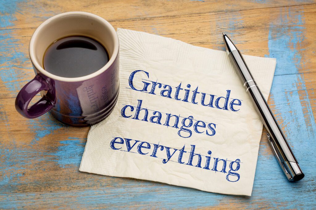 Eighteen Ways to Introduce Gratitude into Your Life - Gratitude changes everything - handwriting on a napkin with a cup of espresso coffee